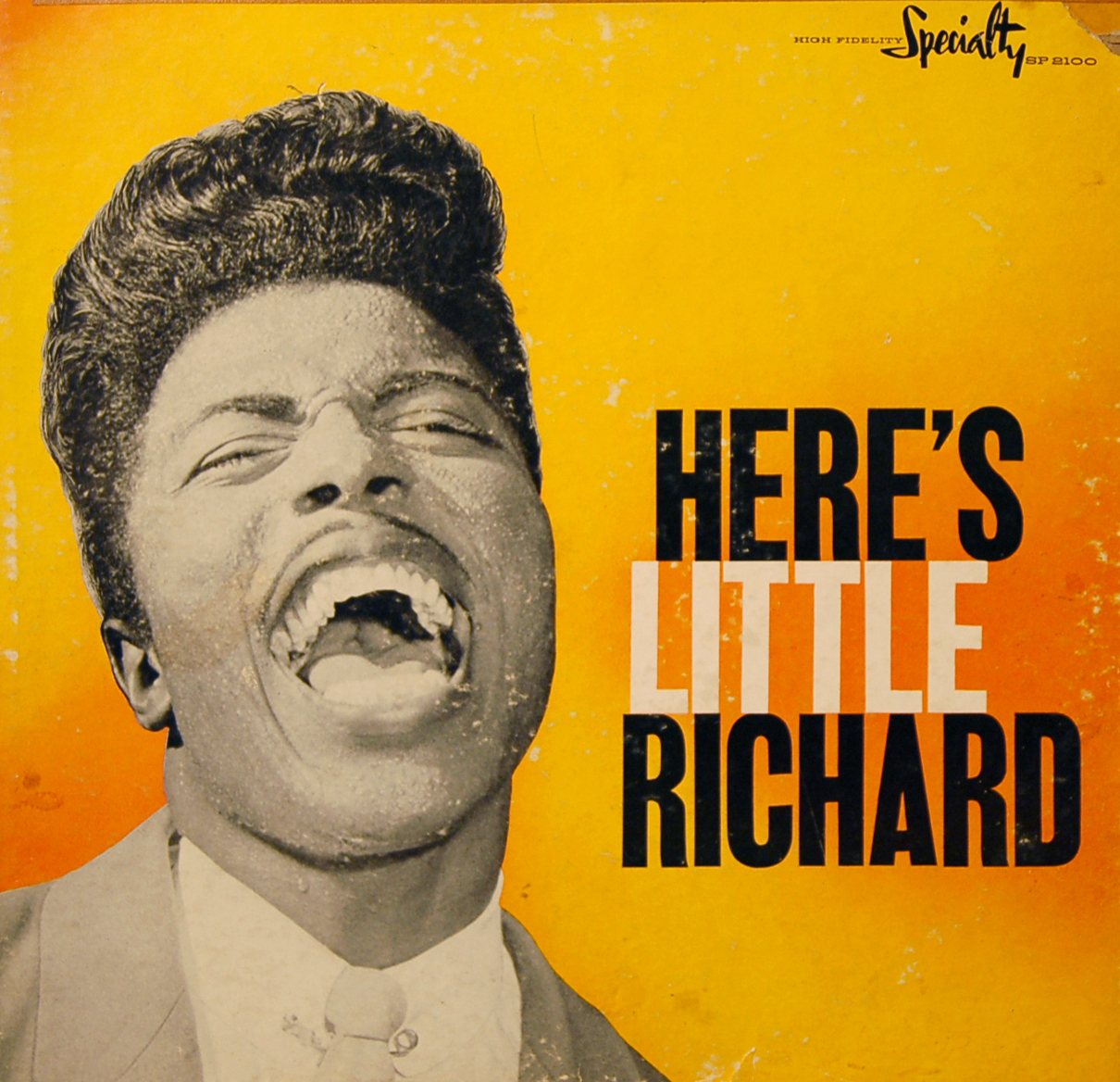 An album cover with a yellow background and a young Little Richard in black-and-white, singing.